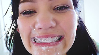 Karly Baker brushes her braced teeth with sperm