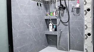 A Thai woman is taking a shower, revealing her pink nipples and smooth, soft vagina while applying body lotion.  Real Thai Solo