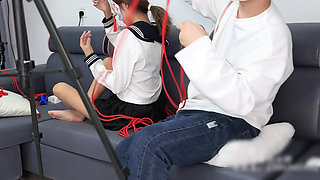 The Barefoot Girl Is Bound with Red Ropes, Tickling Her Feet, and Her Foot Fetishism