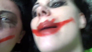 Two crazy clown girls dangle you above their hungry mouths before fighting over who will eat you alive