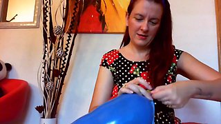 Your beautiful little sister plays with huge balloons