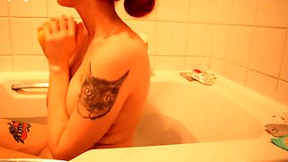 Stacked redhead teen caresses her sexy curves in the bathtub