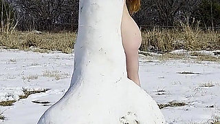 Redhead Slow Strip Rubbing Body on Snow Dick Sculpture